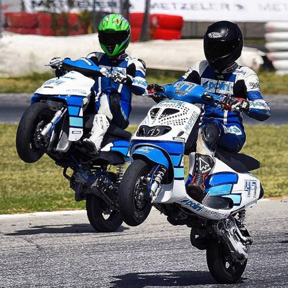 two pilots drive scooters Polini on track race
